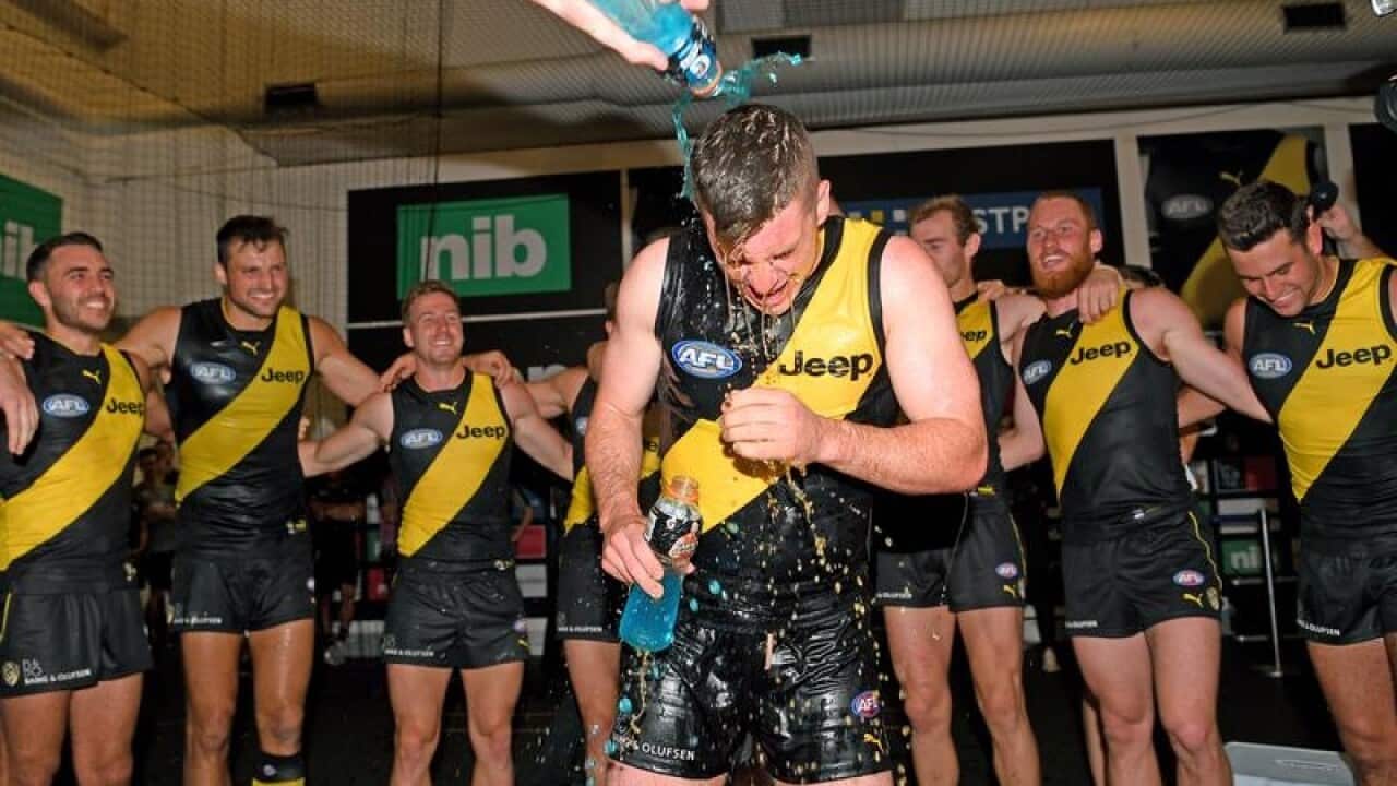 Jack Higgins of the Tigers celebrates with team mates.