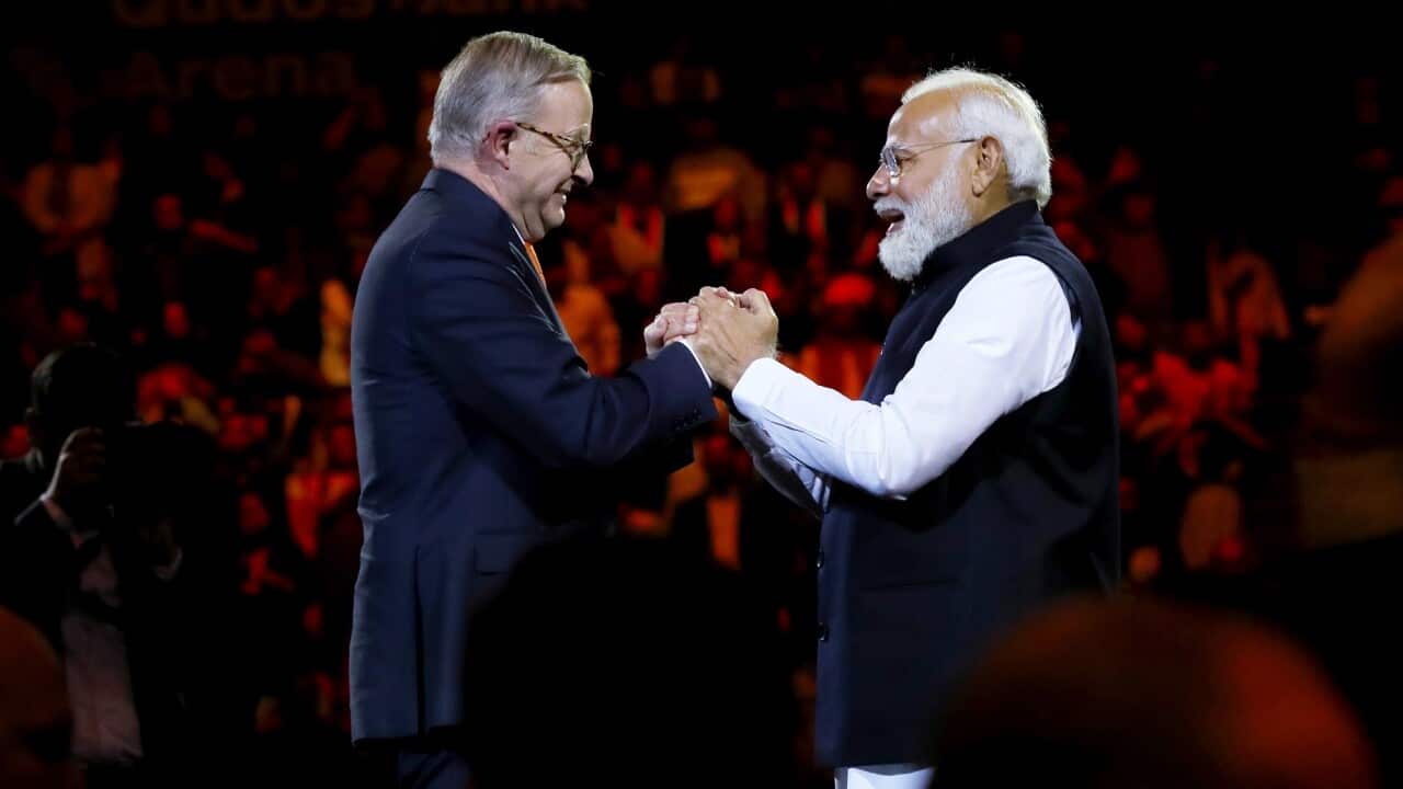 Indian Prime Minister Narendra Modi and Australian Prime Minister Anthony Albanese clasp hands in greeting at Qudos Bank Arena in Sydney on 23 May 2023.