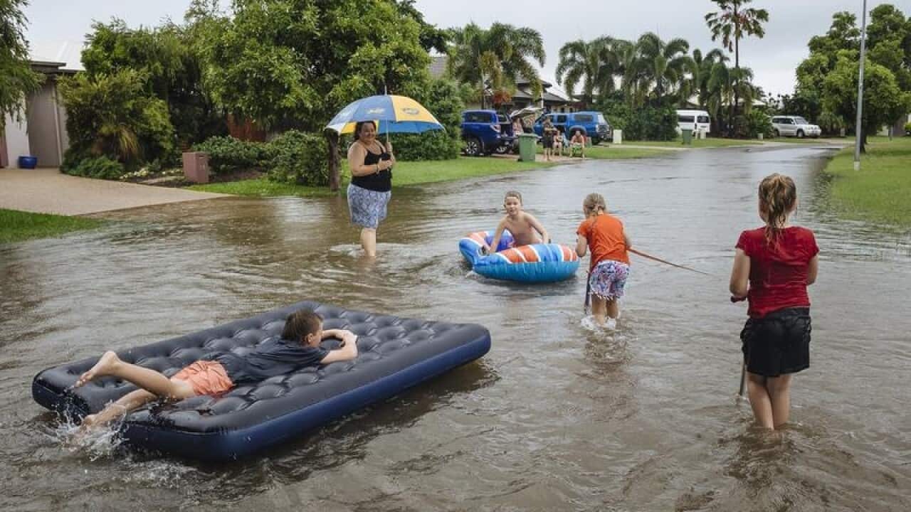 Residents of the suburb of Idalia are seen playing in floodwaters