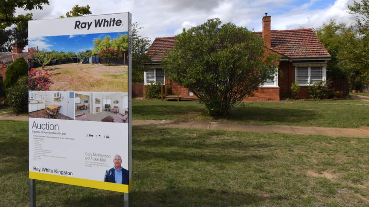 A real estate advertising board is seen in Canberra