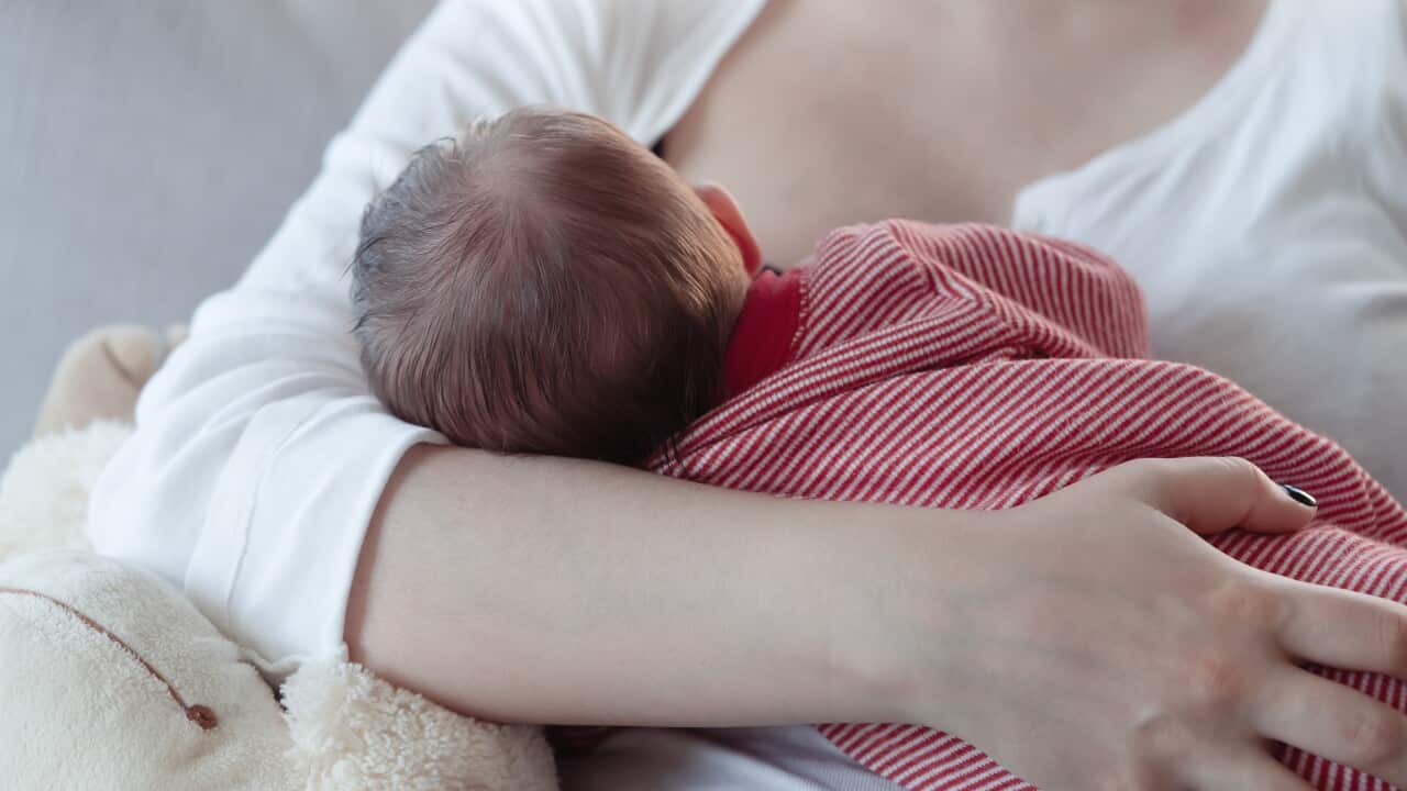 An image of a woman breastfeeding a baby.