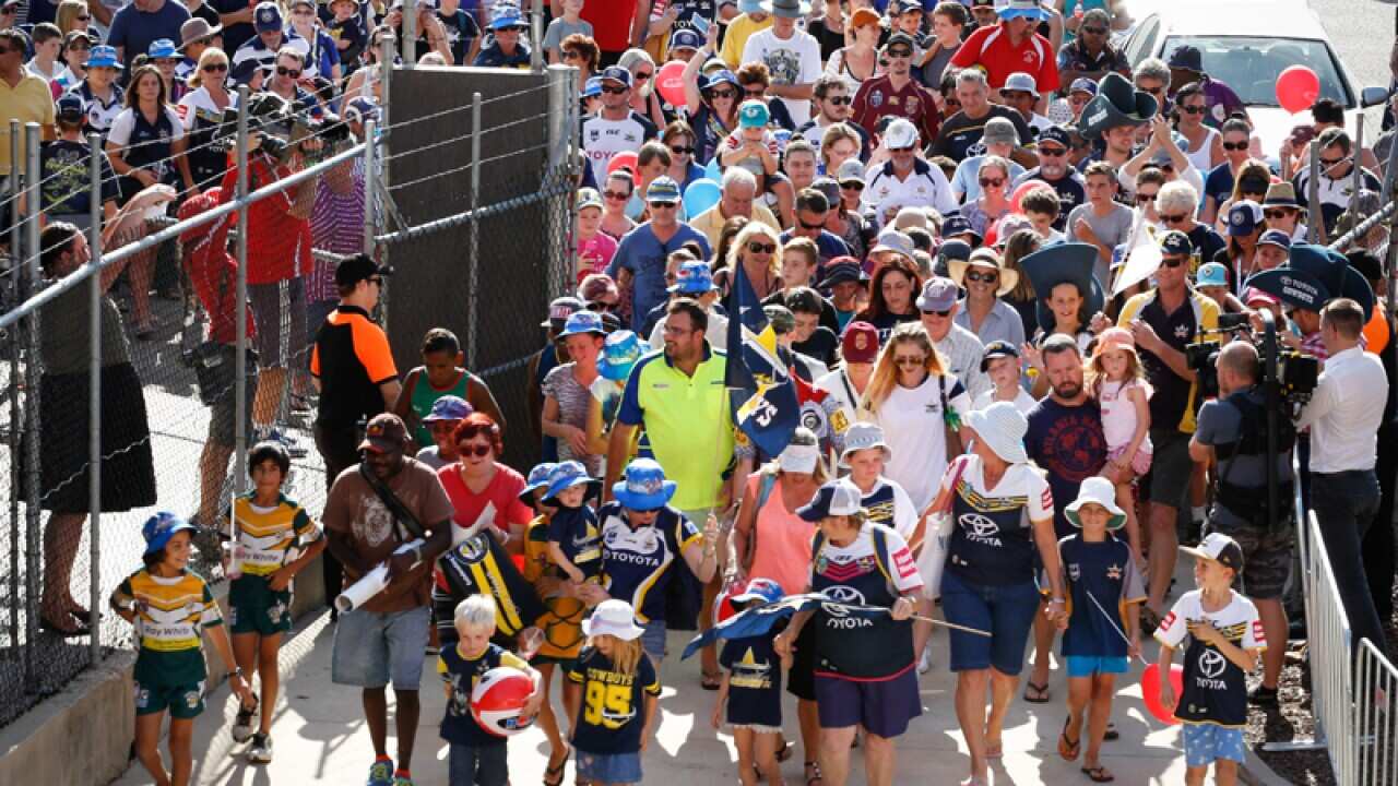A crowd of fans gather to watch the Cowboys training session.