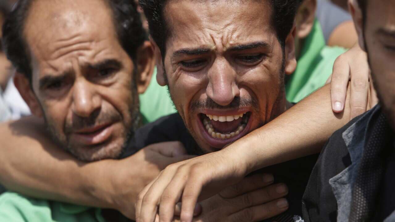 Mourners at a burial of a family in Gaza