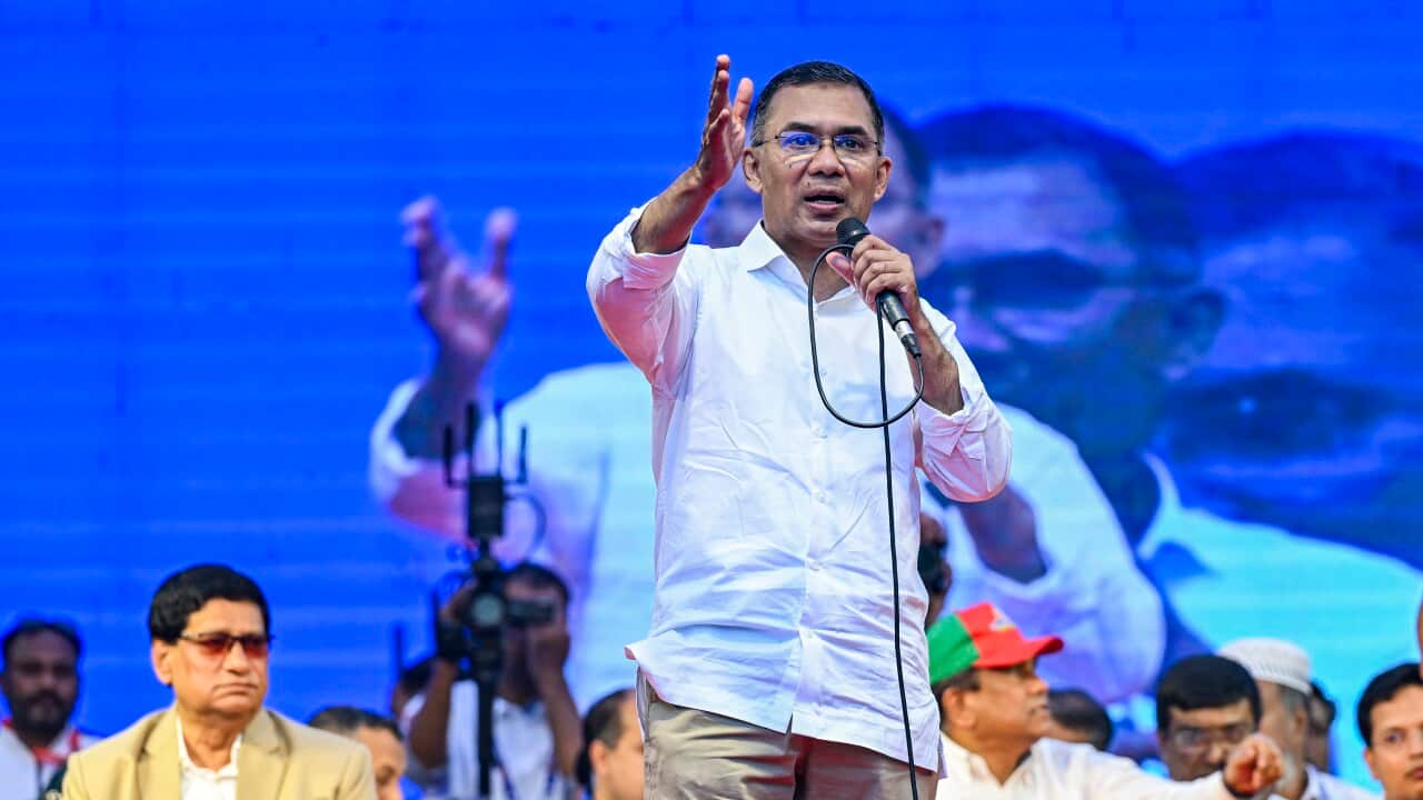 A man holds a microphone as he speaks at a campaign event