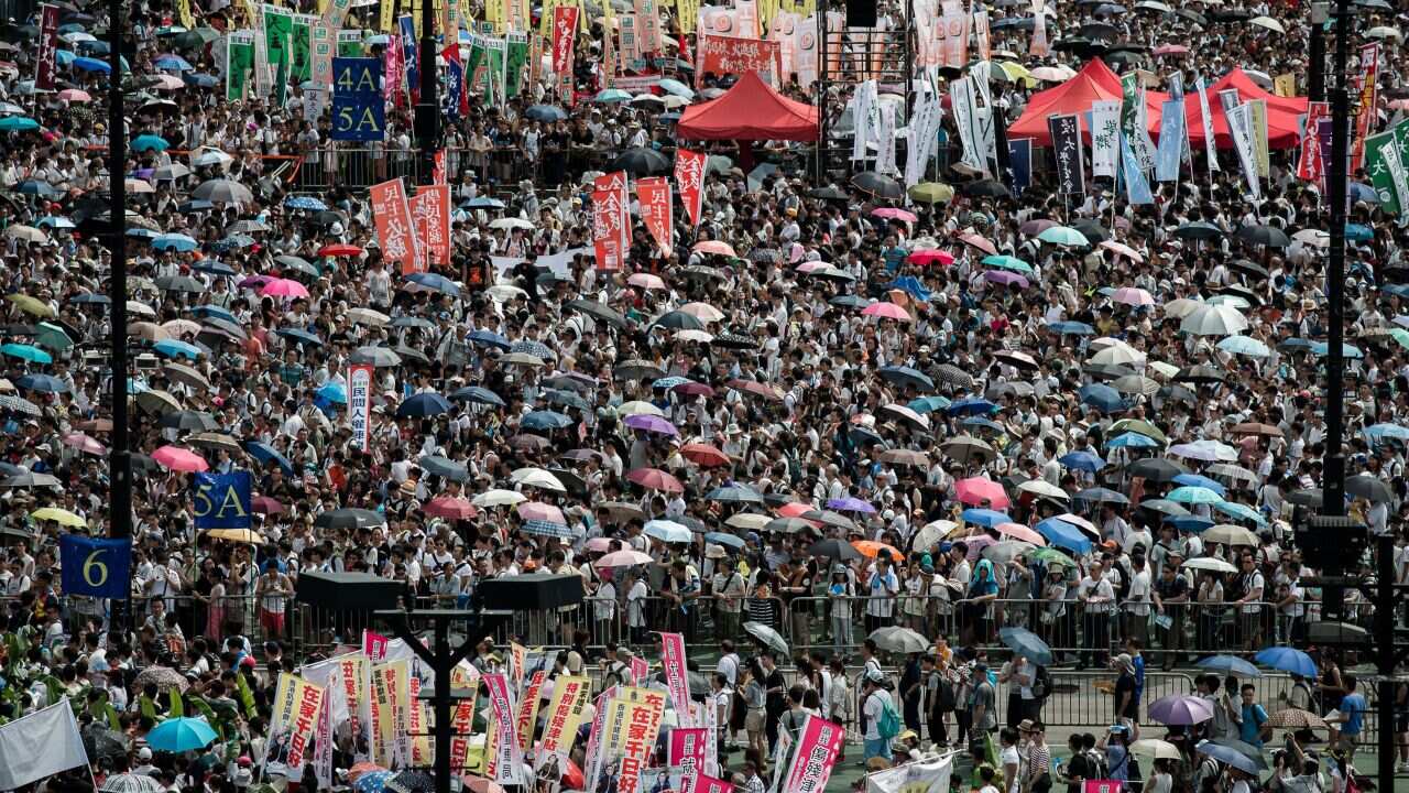 Tens of thousands of people participate in a democracy rally in Hong Kong (Getty/AFP)