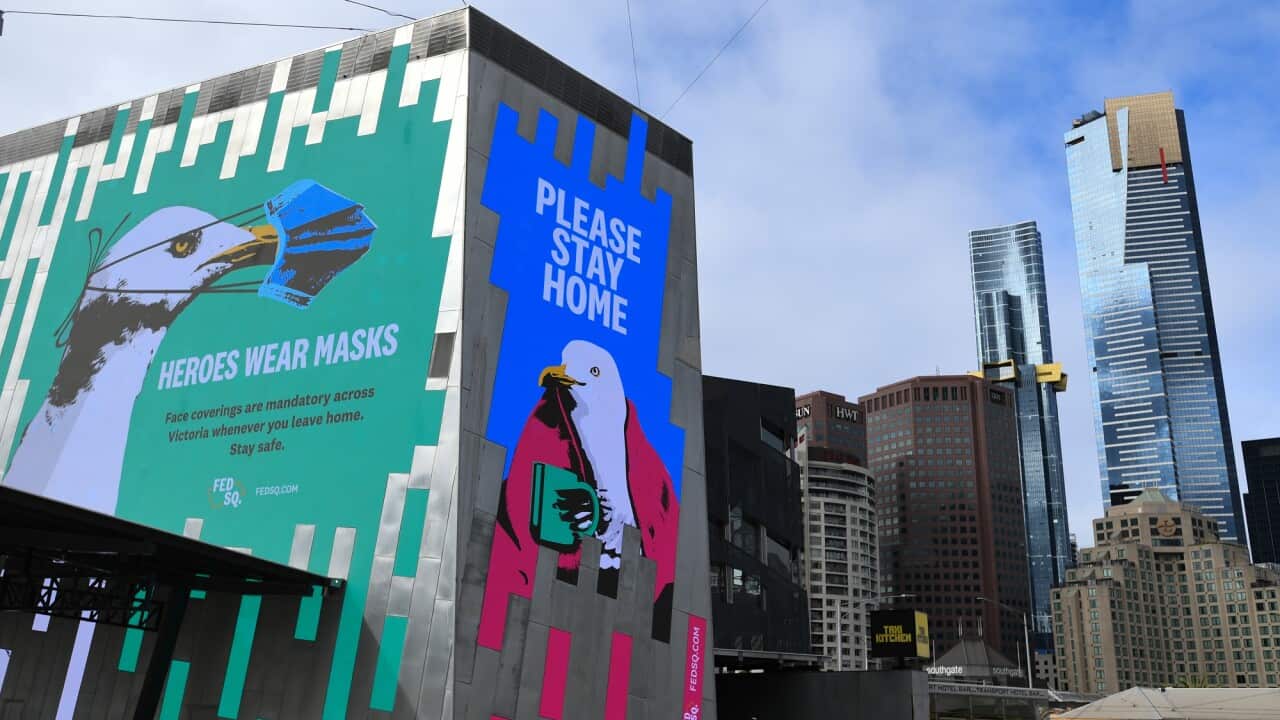 Covid-19 related signage is seen at Federation Square in Melbourne, Saturday, February 13, 2021.