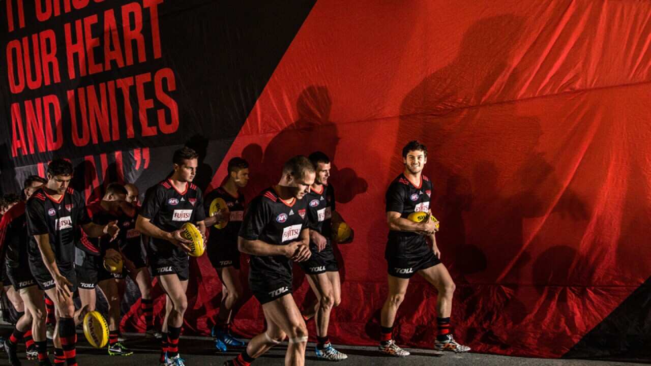 Essendon Bombers walk onto the field.