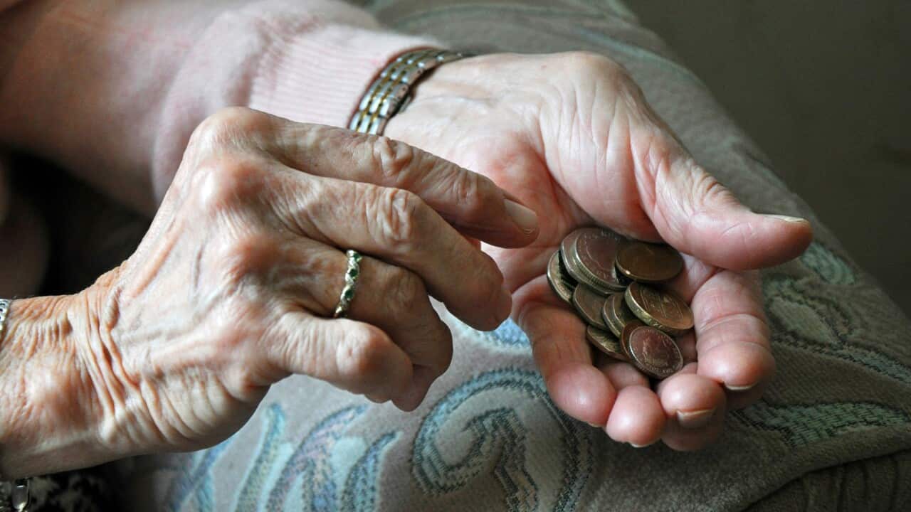 Elderly woman counting loose change