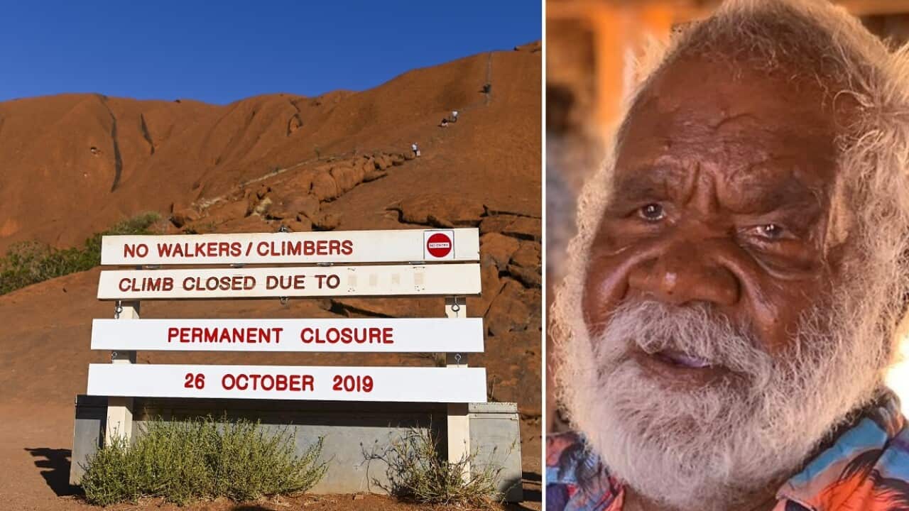 The new sign and traditional owner Reggie Uluru