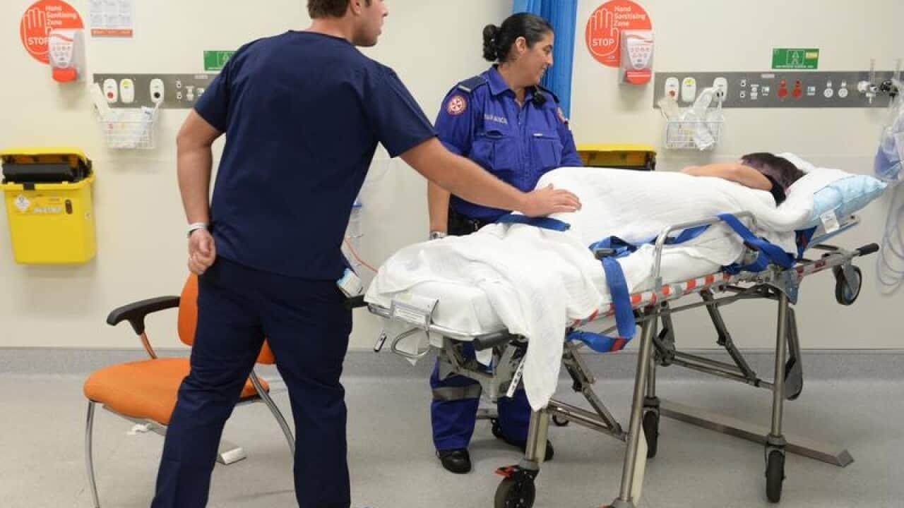Ambulance and medical staff attend to a patient