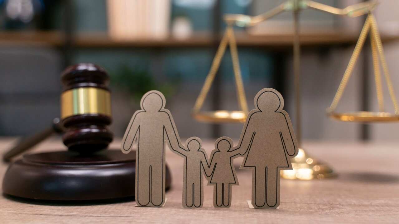 Family law, family right concept. Child-custody concept. Family with children cutout near court gavel