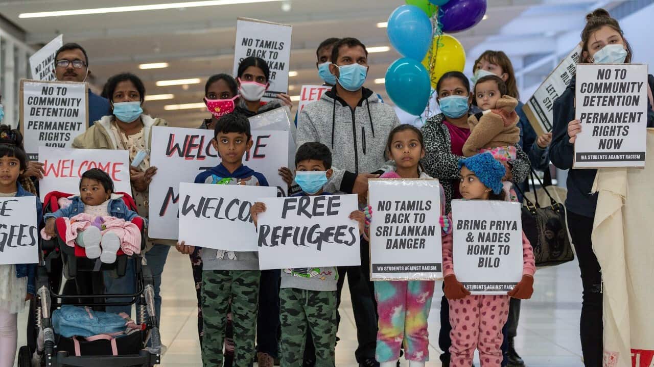 Supporters of the Murugappan family holding signs at Perth airport (AAP)