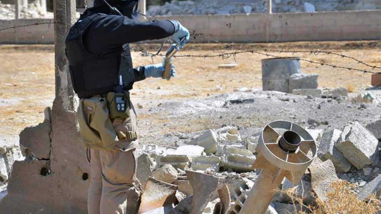 A member of UN investigation team taking samples in Damascus