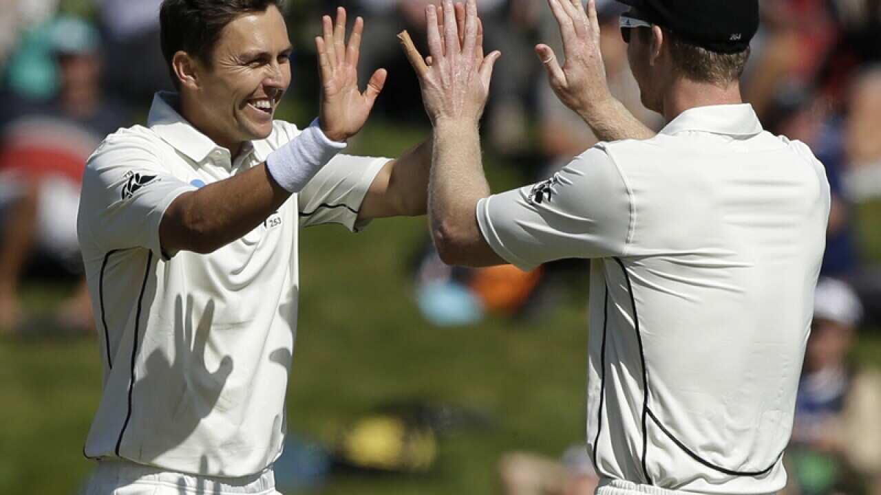 NZ's Trent Boult (L) is congratulated by teammate Jimmy Neesham