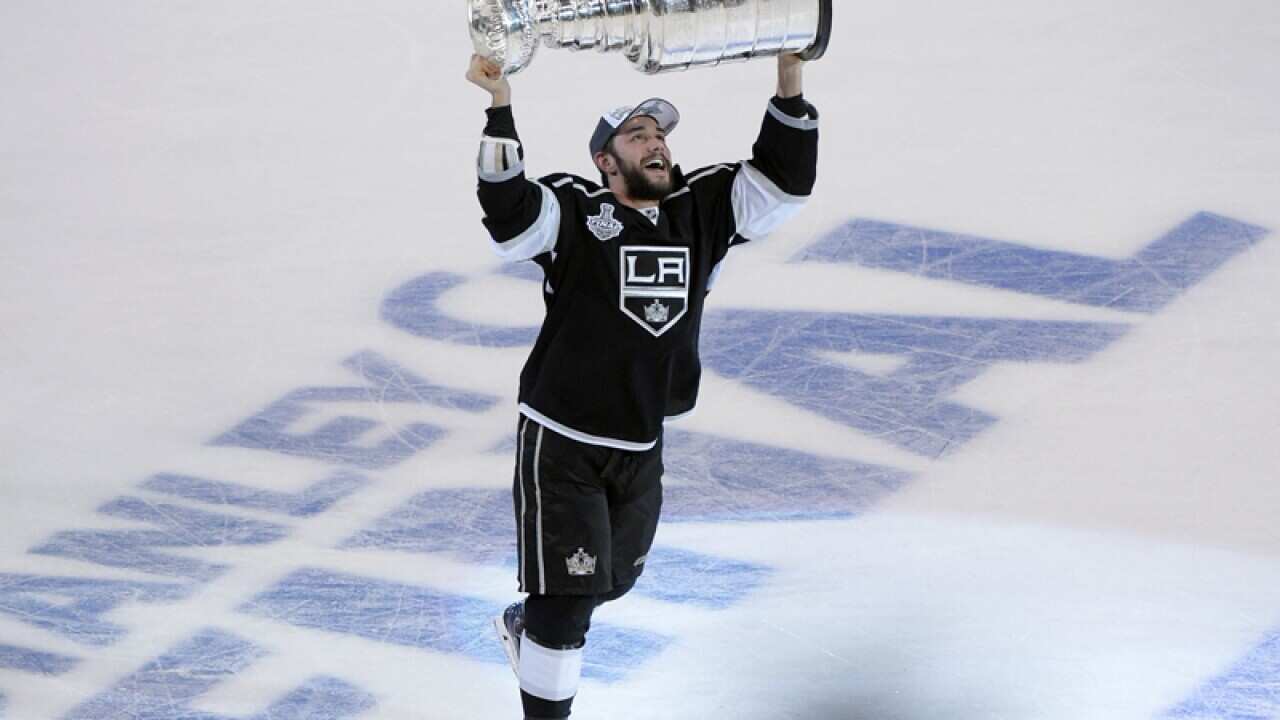 Los Angeles Kings defenseman Alec Martinez carries the Stanley Cup