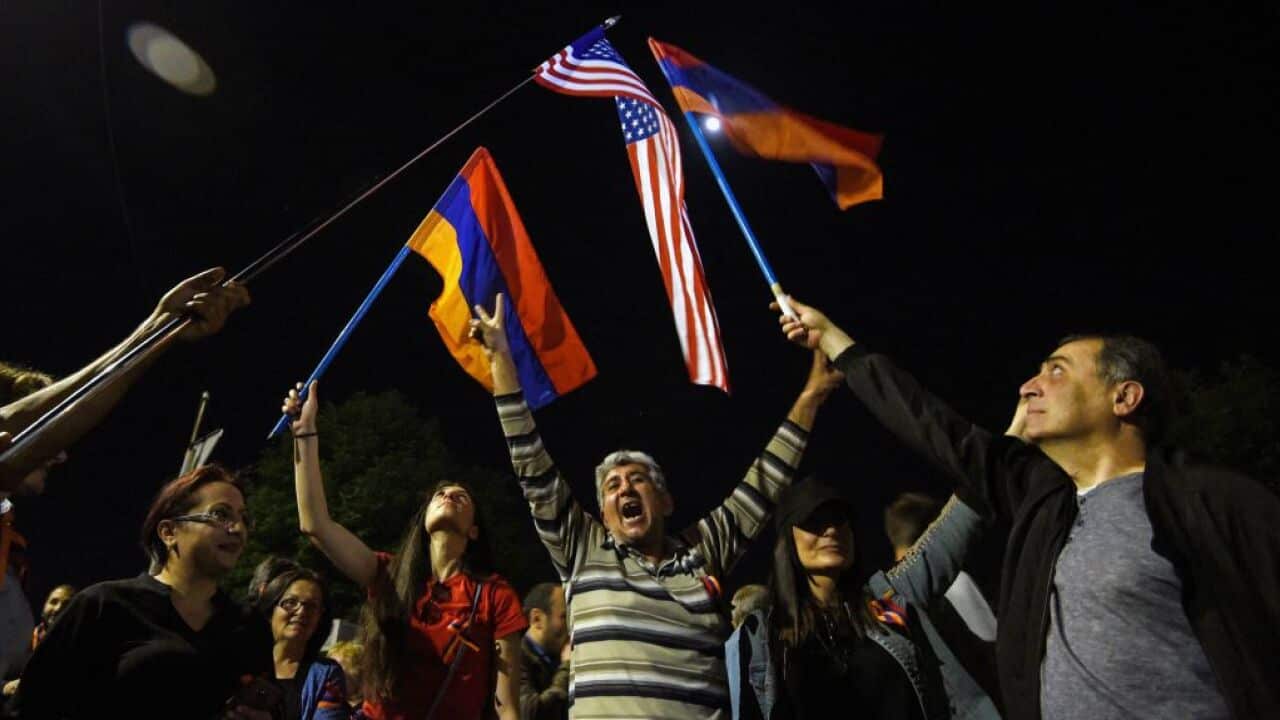 People wave Armenian and US flags in front of the US embassy in Yerevan after US President recognised the 1915 killings of Armenians by Ottoman forces as genocide.