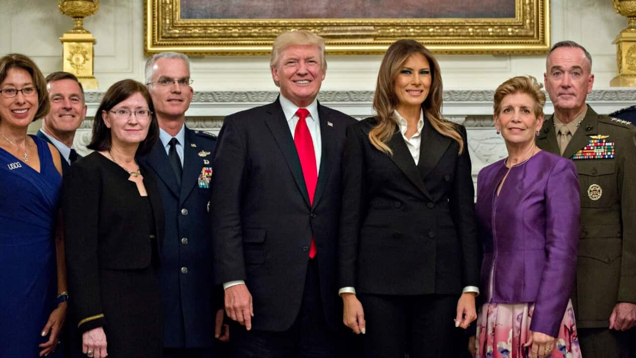US President Donald J. Trump (C-L) and US First Lady Melania Trump (C-R) pose for an official photograph with senior military leaders and spouses 