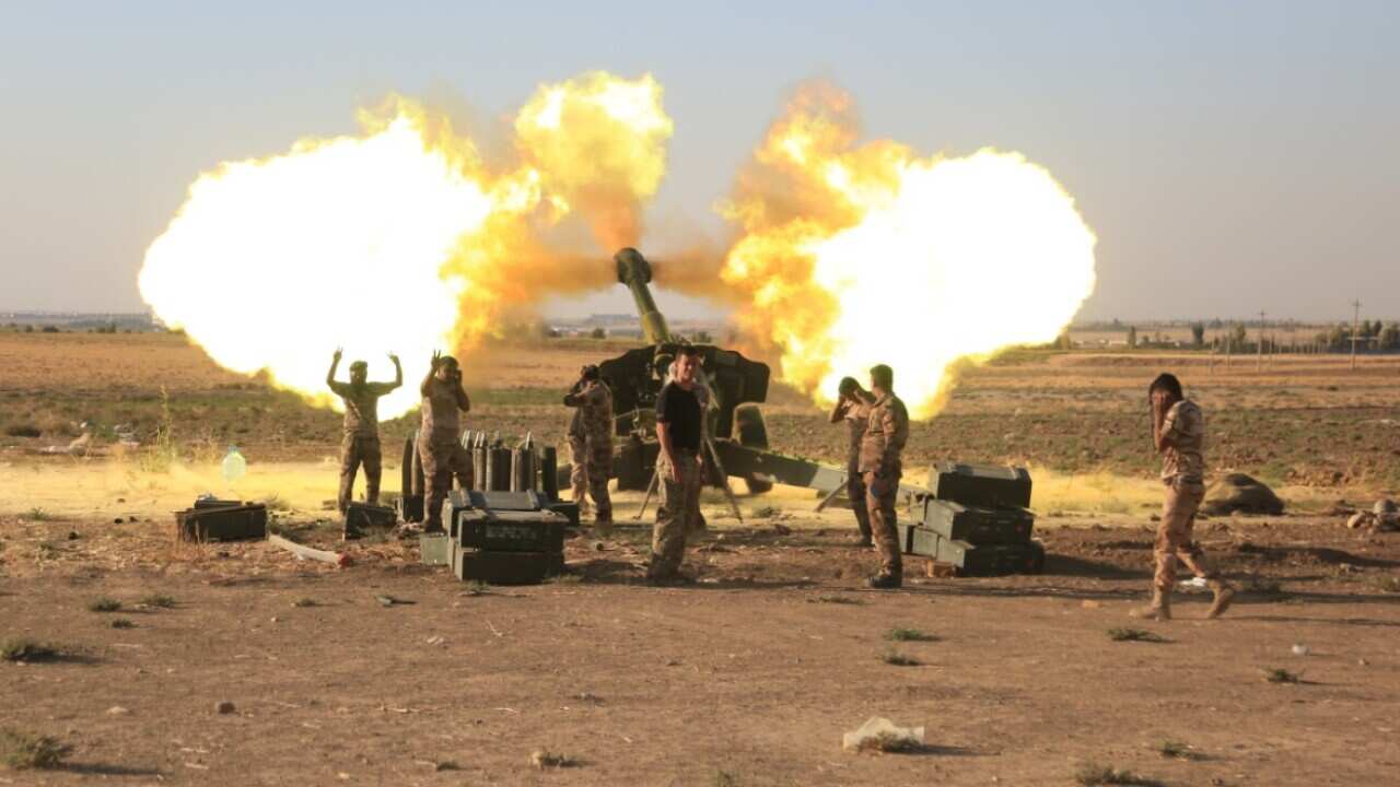 Firing of cannon shot can be seen as Iraqi forces advance to take control of Altun Kupri, south of Arbil in Iraq as they clash with the Kurdish military