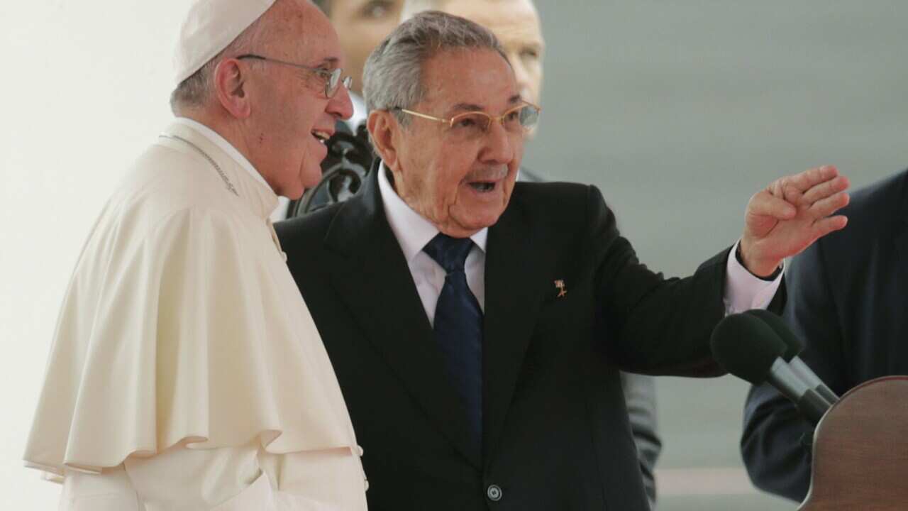 Pope Francis speaks with Cuba's President Raul Castro during his arrival ceremony at the airport in Havana
