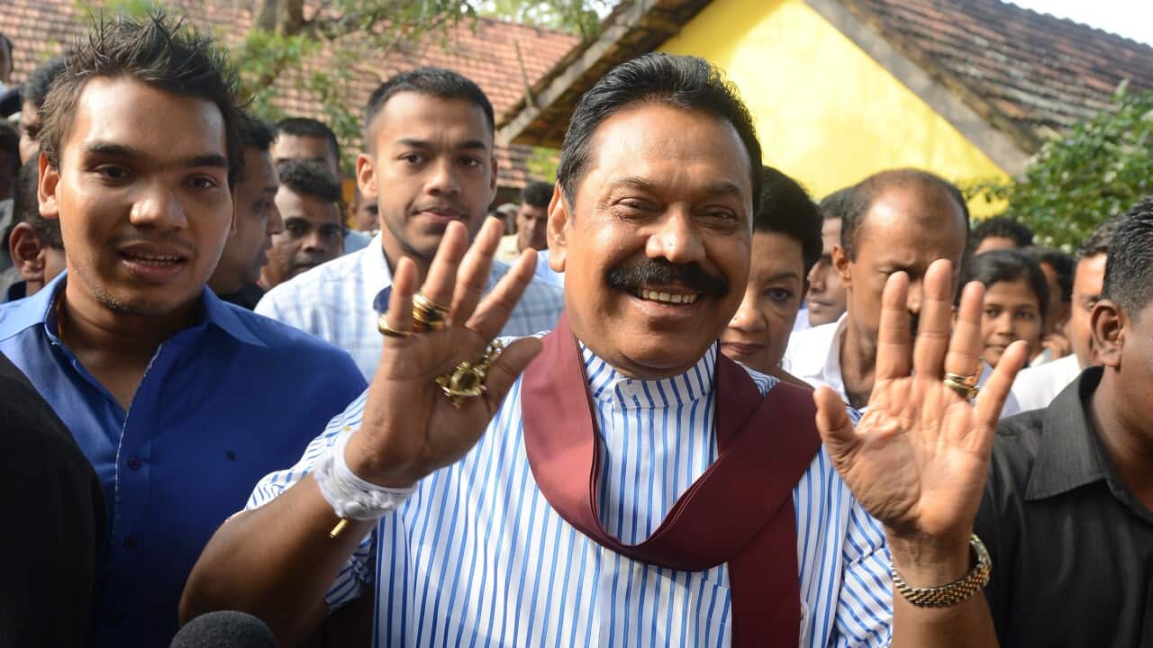 Former Sri Lankan president Mahinda Rajapakse (C) at polling station in Tangalla, about 195 kms from Colombo on January 8, 2015. Sri Lanka went to the polls on January 8, 2015 (LAKRUWAN WANNIARACHCHI/AFP/Getty)