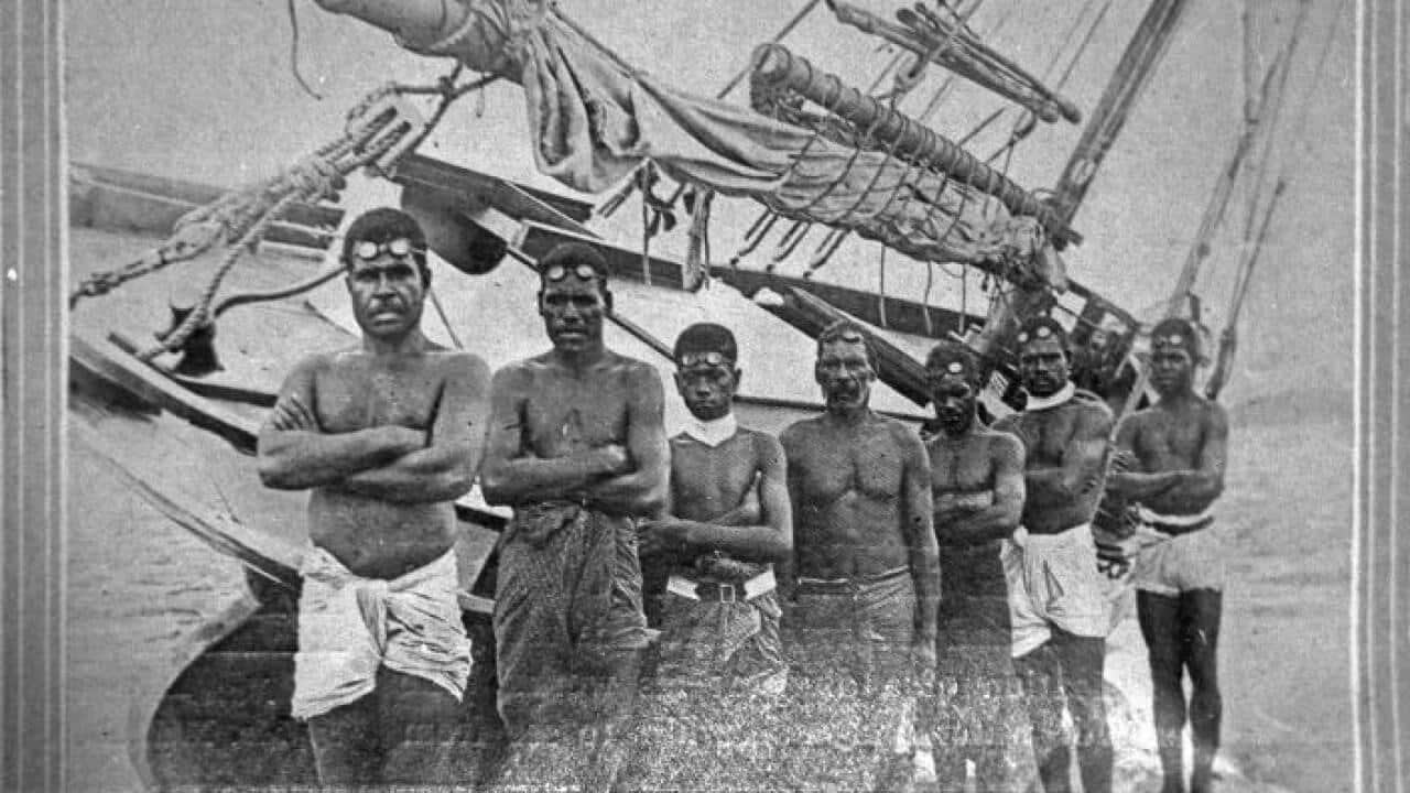 A group of Torres Strait Islander divers in front of their cutter-rigged lugger, c. 1921. 
