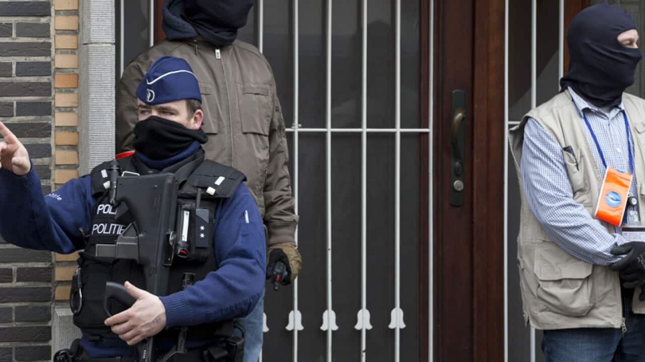 Belgium police stand guard during an investigation
