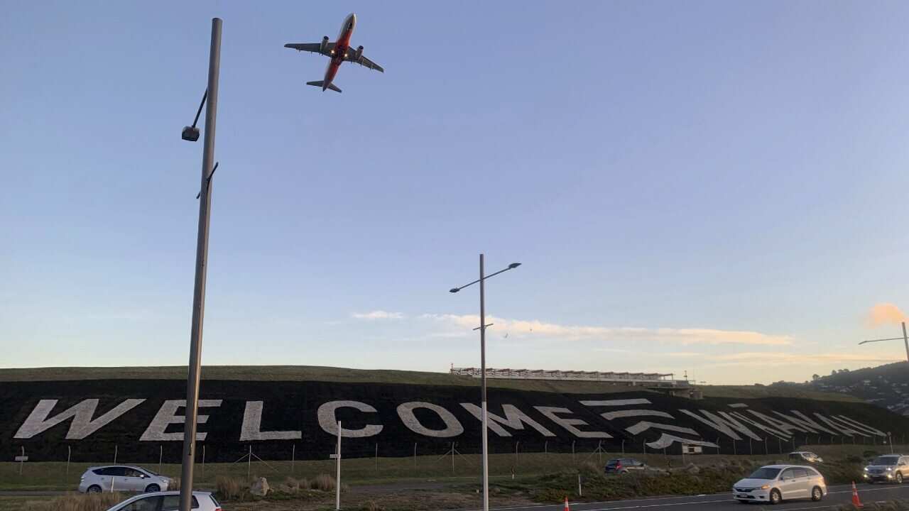 A giant 'Welcome' sign is painted near the main runway of the Wellington International Airport.