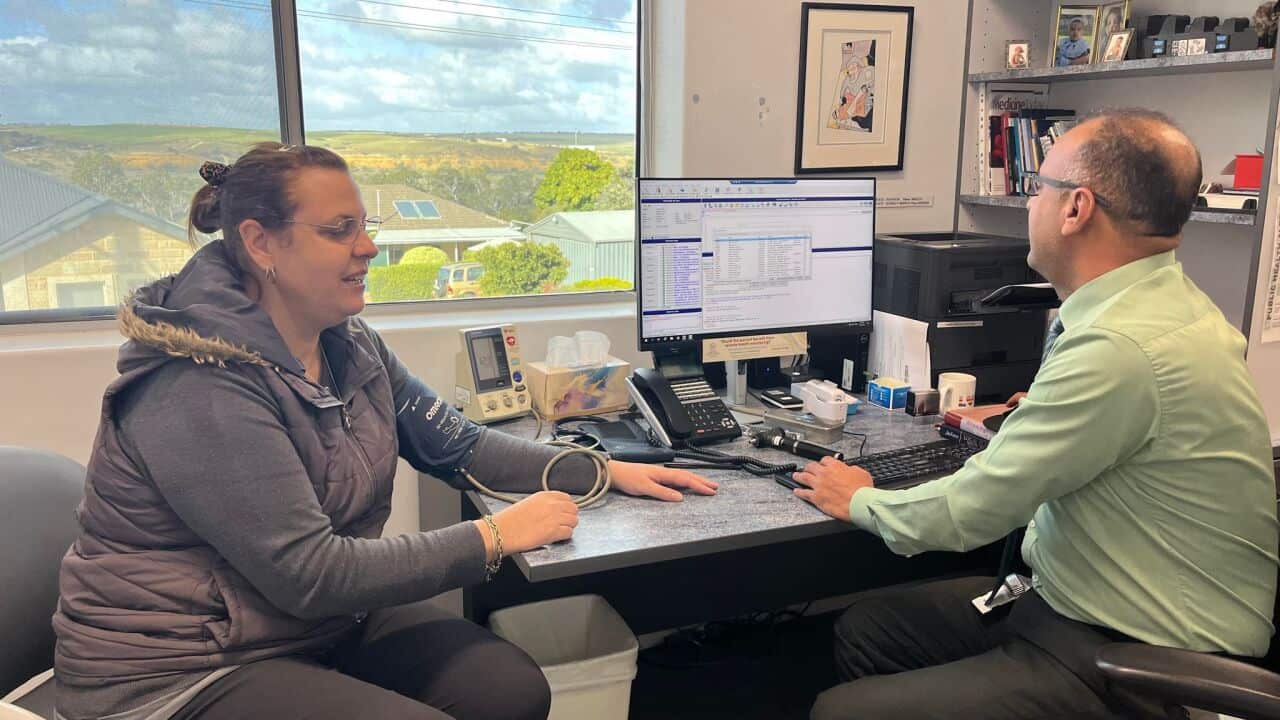 Dr Hamoudi with a patient.jpg