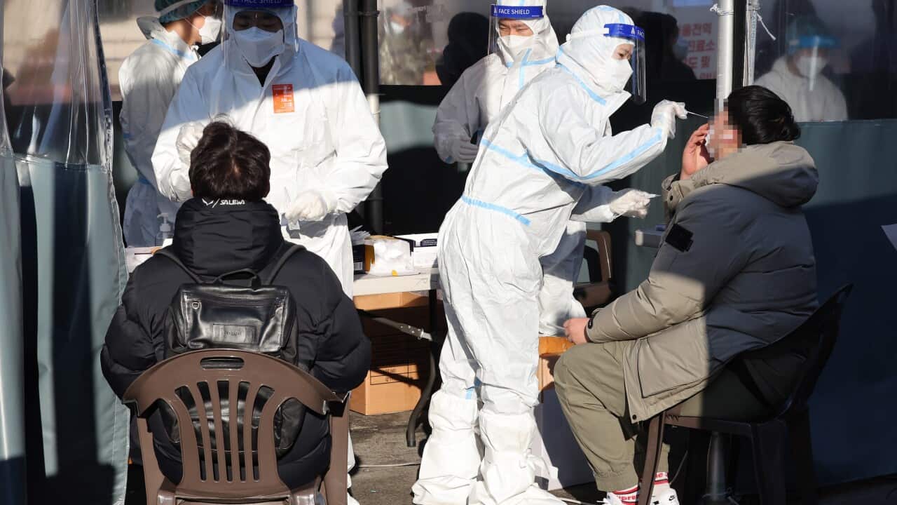epa09726328 Medical workers carry out rapid antigen tests as the country reported 27,443 new cases at a Covid-19 testing station in Seoul, South Korea, 04 February 2022. EPA/YONHAP SOUTH KOREA OUT