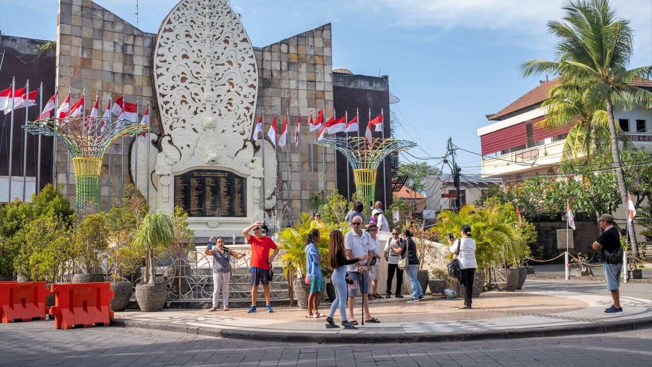 Tourists visit the 2002 Bali Bombing Memorial monument in Kuta, Bali, Indonesia