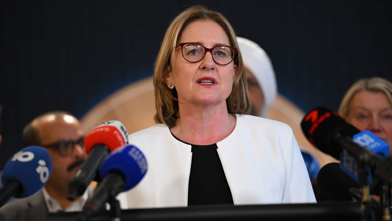 Premier Jacinta Allan speaks from podium to an array of media microphones