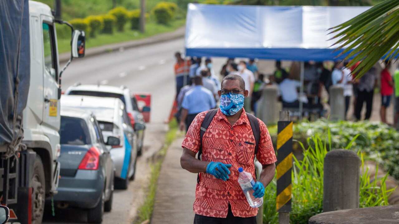 Security officers in Suva check cars along a road in April.