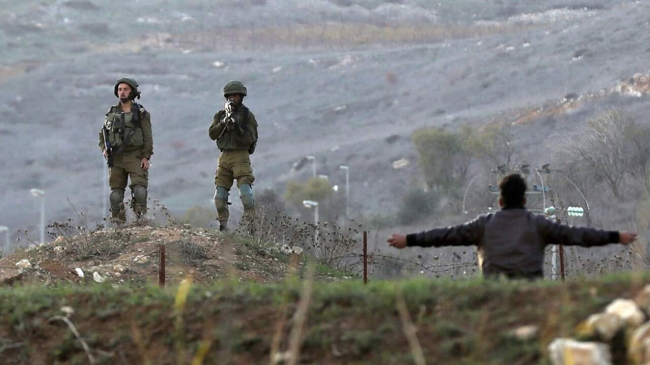 A Palestinian hurls stones at Israeli soldiers during clashes with Israeli troops at Huwwara checkpoint near the West Bank City of Nablus.