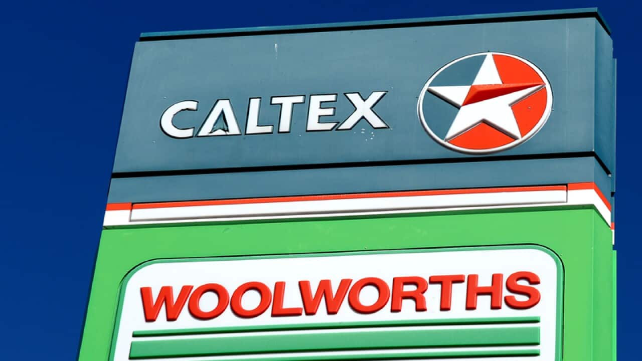 Signage displayed at a Woolworths service station