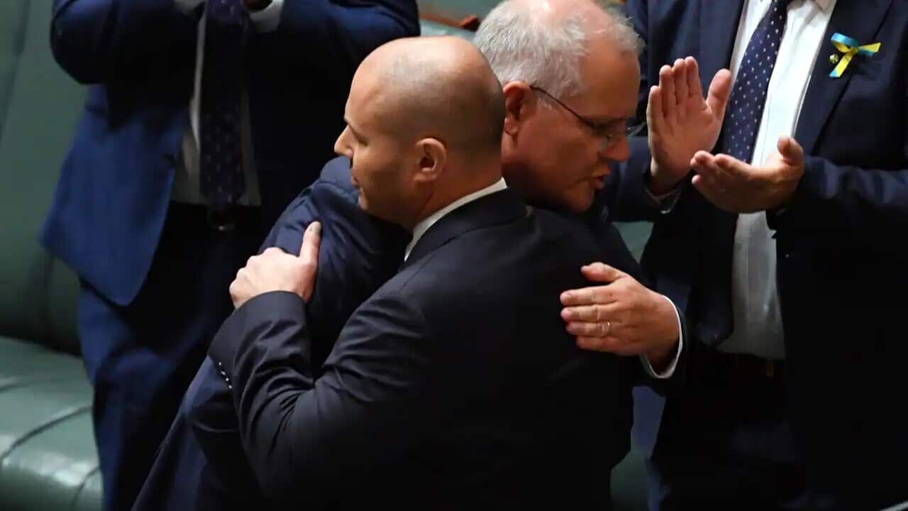 Prime Minister Scott Morrison (left) hugs Treasurer Josh Frydenberg after Mr Frydenberg handed down his fourth budget in the House of Representatives at Parliament House in Canberra.