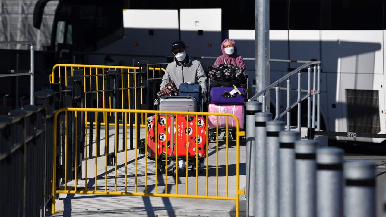 A return traveler prepares to board a quarantine bus at Sydney International Airport in Sydney, Wednesday, September 8, 2021. (AAP Image/Joel Carrett) NO ARCHIVING