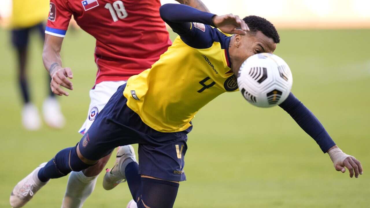 Ecuador's Byron Castillo (4), is fouled by Chile's Sebastian Vegas during a World Cup Qatar 2022 qualifying soccer match at the Rodrigo Paz Delgado stadium in Quito, Ecuador, Sunday, Sept.5, 2021. (AP Photo/Dolores Ochoa, Pool)