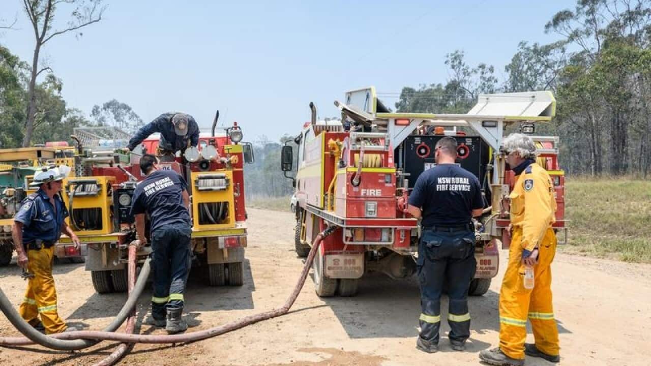 Rural fire fighters refill their fire trucks