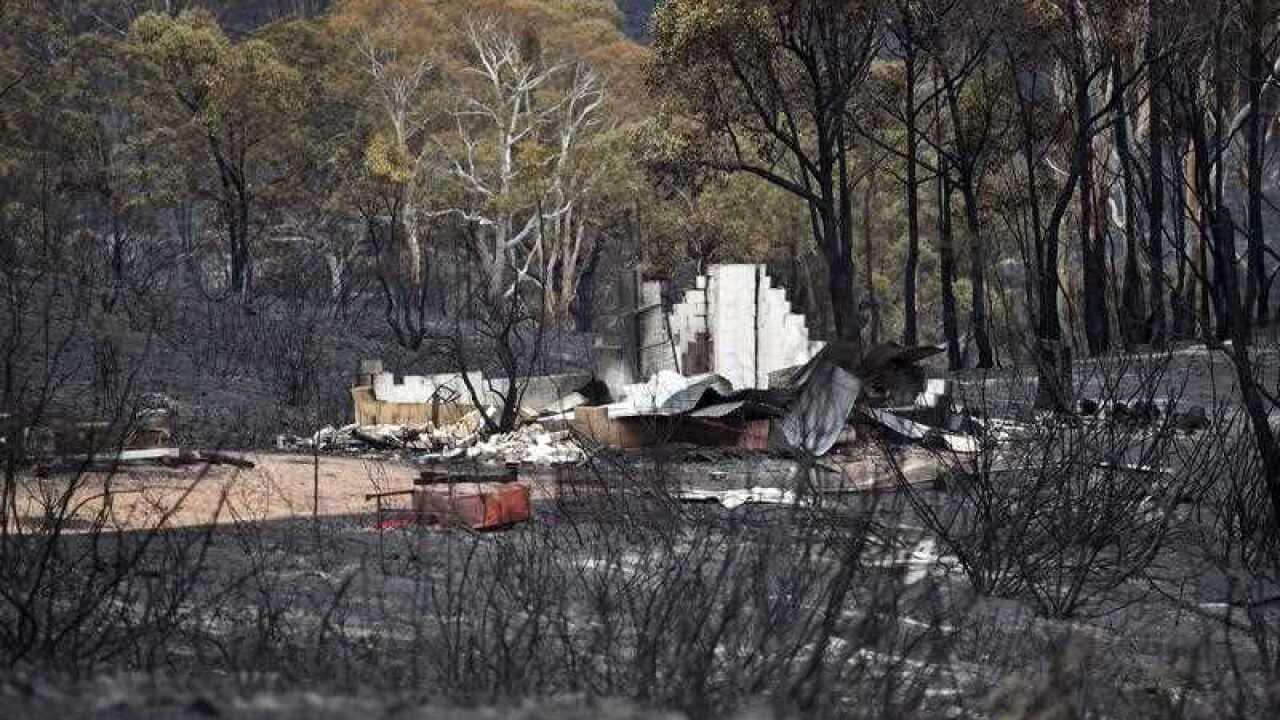 A burnt out building is seen after an out of control bushfire broke out yesterday at Carwoola, east of Queanbeyan near in Canberra