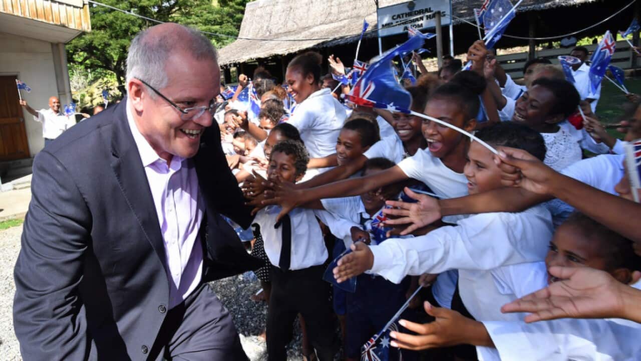 Australian Prime Minister Scott Morrison is seen with children at St Barnabas Anglican Cathedral in Honiara in the Solomon Islands, on Monday, June 3, 2019.