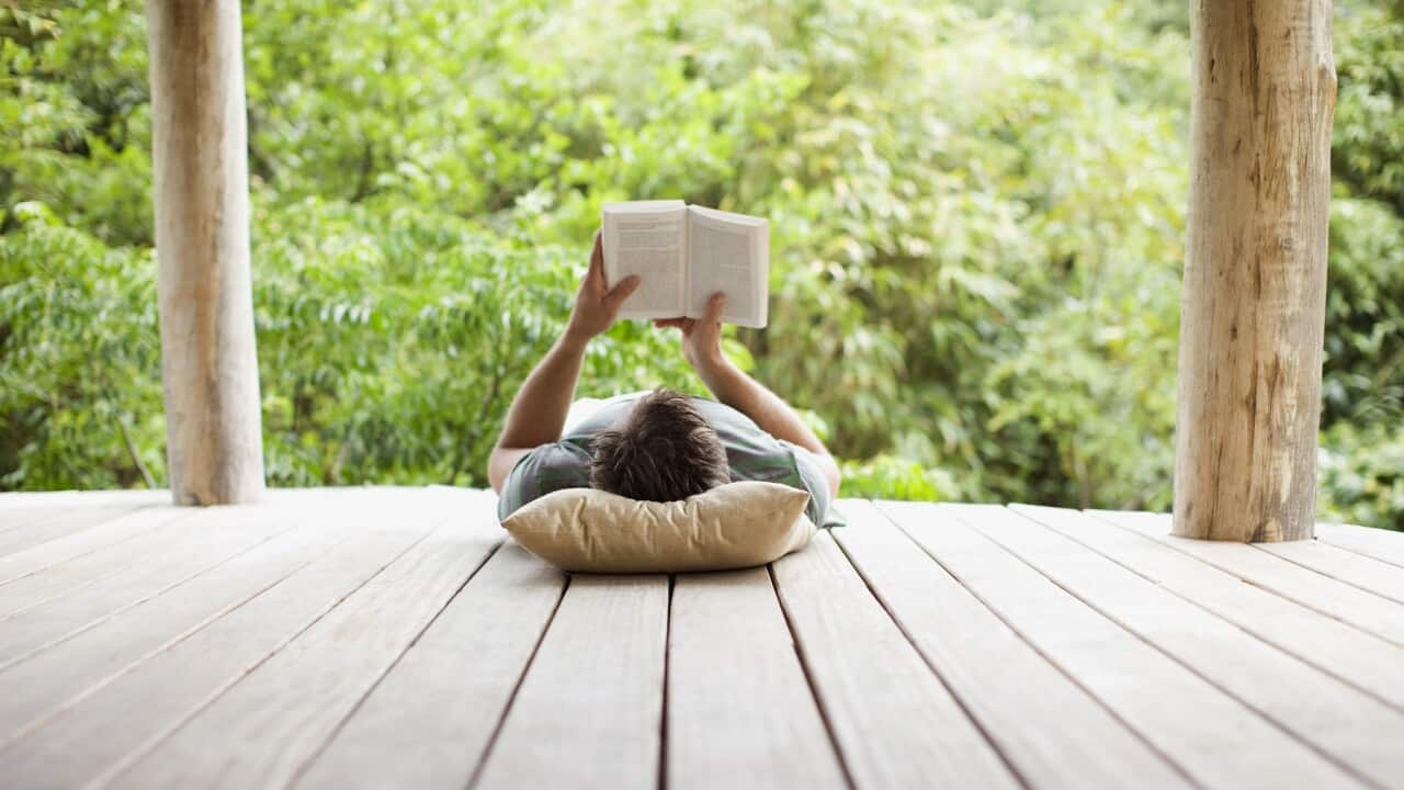 Man reading on porch in remote area