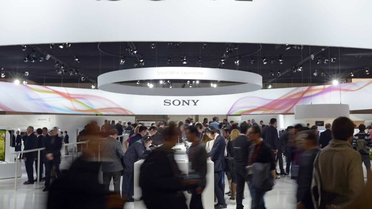 Visitors walk past a Sony's stand at the Mobile World Congress