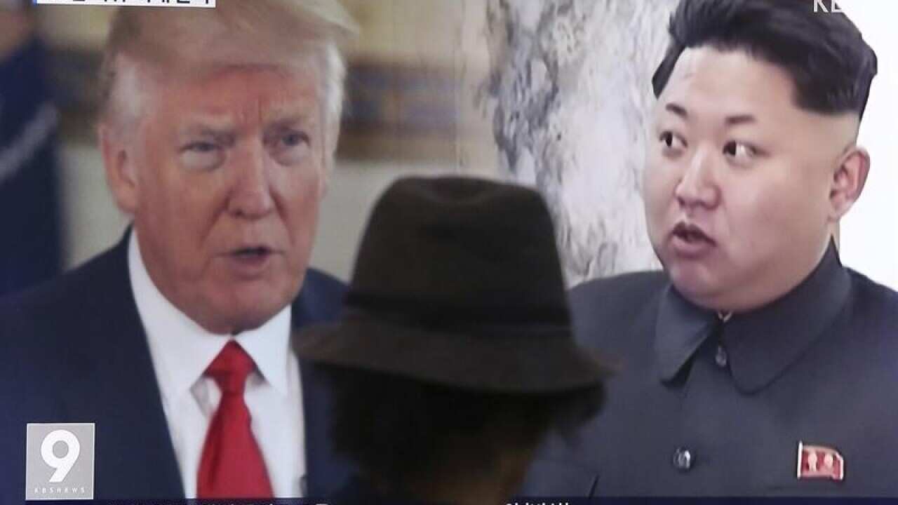 A TV showing US President Donald Trump and North Korea's Kim Jong Un