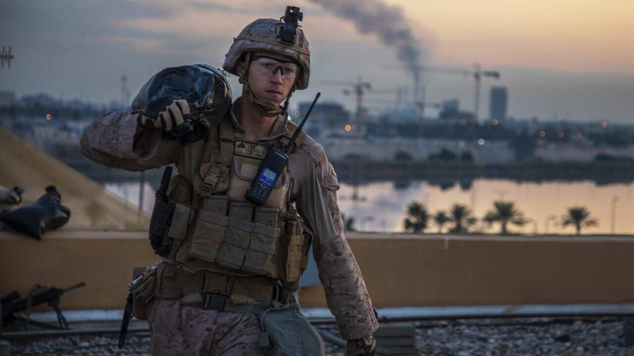 An American soldier carries a sandbag during the reinforcement of the US embassy compound in Baghdad, Iraq, 4 January 2020.