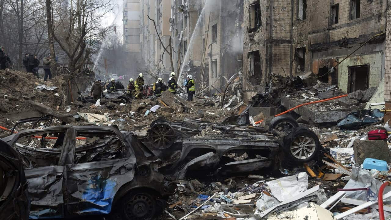 Firefighters work to extinguish a fire in a destroyed apartment building after a Russian attack in Kyiv (AAP)