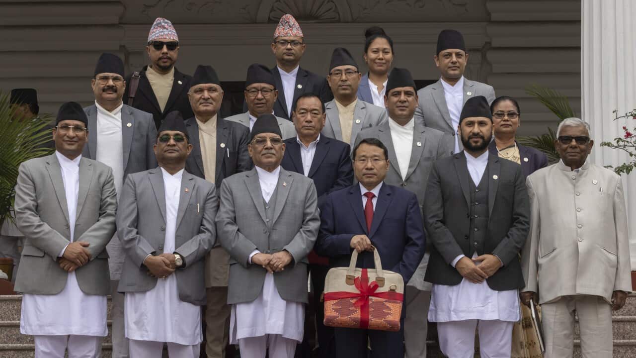 Nepal's Prime Minister Pushpa Kamala Dahal (3-L) stands next to Finance Minister Barshaman Pun (3-R) as the latter displays the budget briefcase while posing for a photo with other cabinet members, before presenting the budget for the fiscal year 2024-25 at the joint meeting of the federal parliament in Kathmandu, Nepal on 28 May 2024.