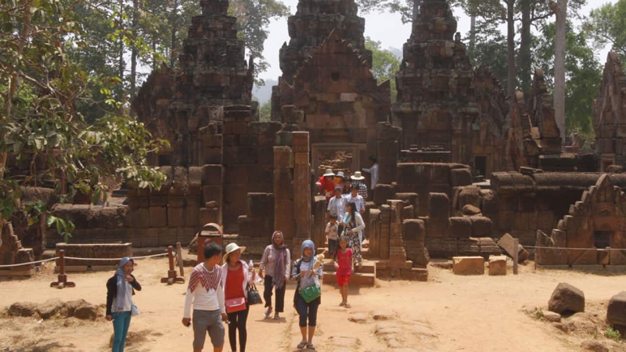 Tourist walk at Banteay Srey temple of Angkor complex, Cambodia