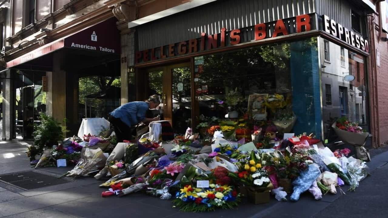 Floral tributes are seen outside Pellegrini's Espresso Bar