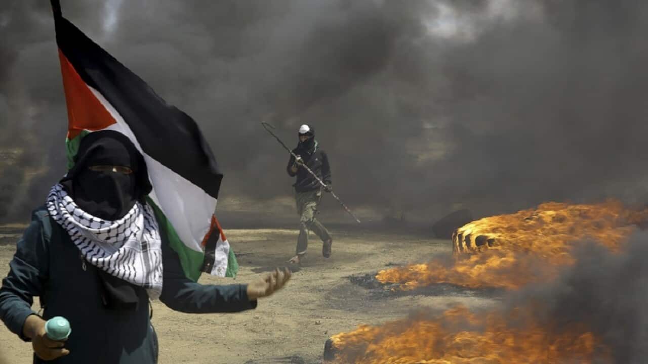 Protester burns tires near the Israeli border fence in the Gaza Strip on May 14.