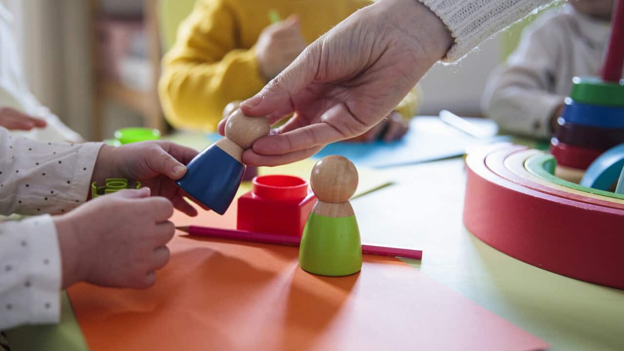 Preschool children playing with colorful shapes